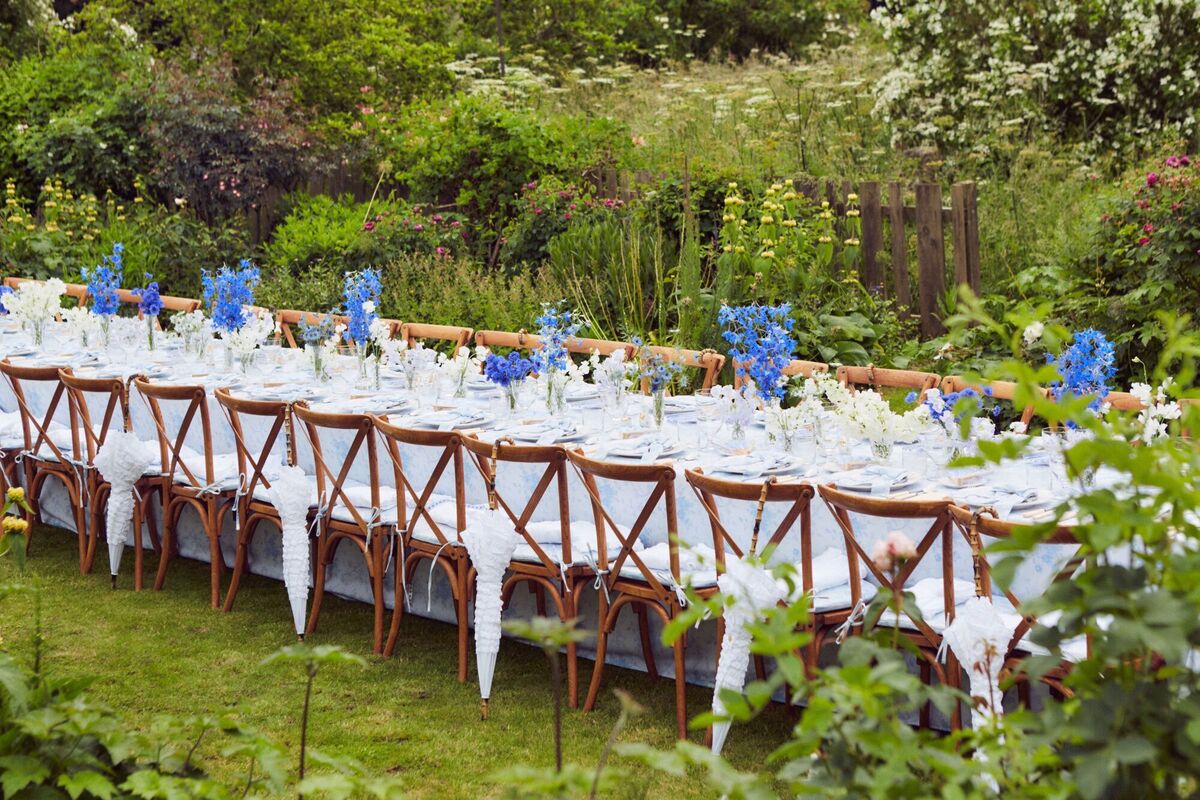  An elegant outdoor summer tablescape Fiona designed for fashion brand Love Shack includes a parasol at each setting for a decorative and practical touch.