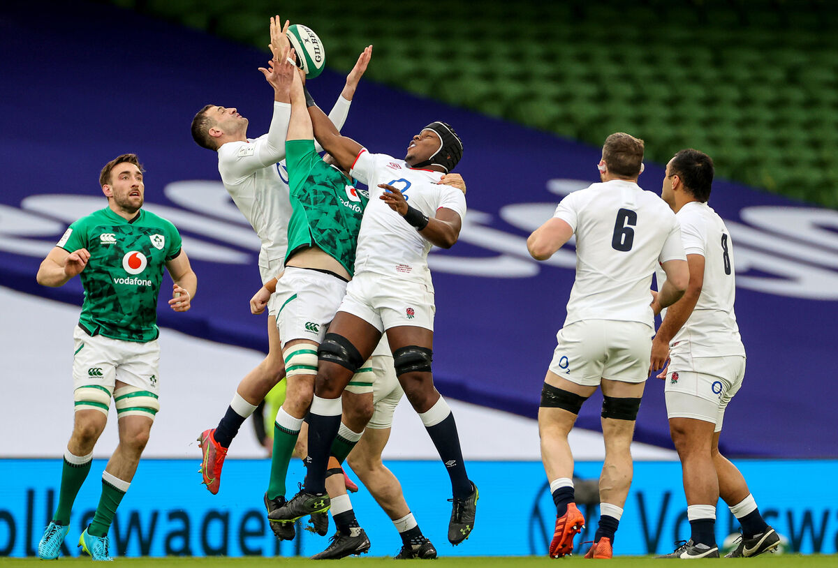 England's Jonny May and Maro Itoje compete for possession in the air. Picture: INPHO/James Crombie