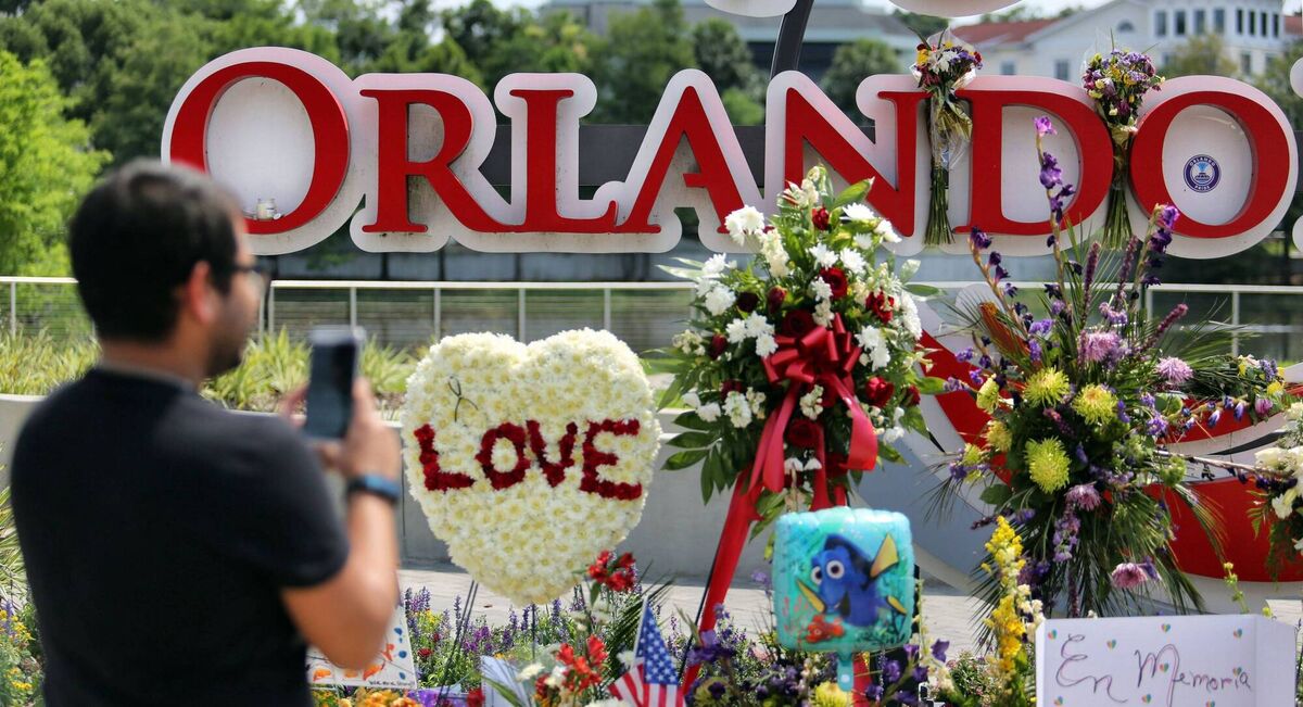 Jose Acevido Negron of Altamonte Springs, Fla. takes a photo with his iPhone as visitors continue to pay their respects at a makeshift memorial at Orlando Regional Medical Center, a few blocks from the Pulse nightclub in Orlando, Fla., Tuesday, June 14, 2016. Picture: Joe Burbank/Orlando Sentinel via AP Jose Acevido Negron of Altamonte Springs, Fla. takes a photo with his iPhone as visitors continue to pay their respects at a makeshift memorial at Orlando Regional Medical Center, a few blocks from the Pulse nightclub in Orlando, Fla., Tuesday, June 14, 2016. Picture: Joe Burbank/Orlando Sentinel via AP
