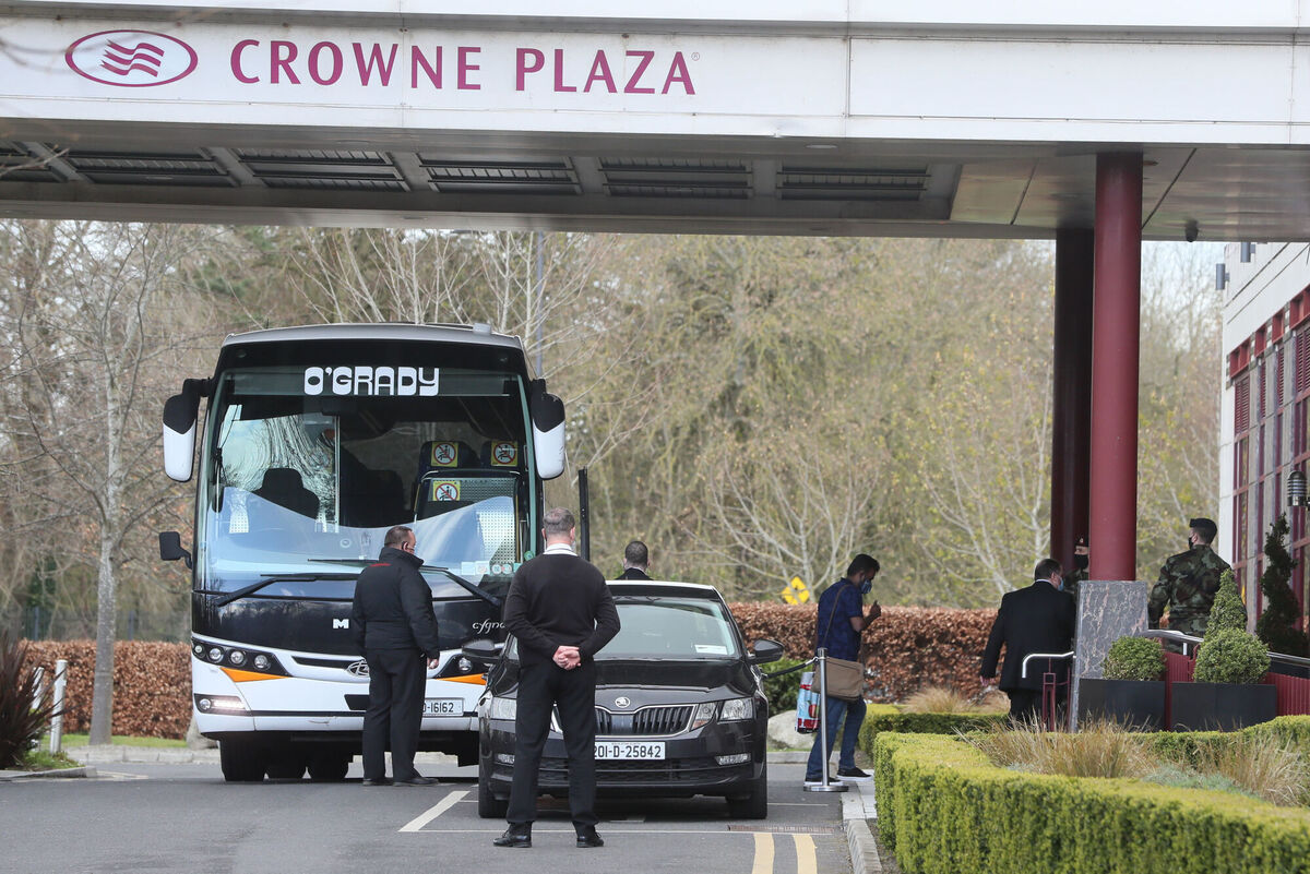 Travellers leave a bus outside the Crowne Plaza hotel, Santry, near Dublin Airport, where they will stay during a mandatory 12-day quarantine after arriving from one of 33 high risk countries. Picture: Brian Lawless/PA Wire