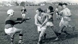 <p>Micheál Murphy (left) wearing an American football helmet for UCC in the Fitzgibbon Cup in March 1968. After sustaining a serious head injury while playing for UCC in 1964, Murphy first wore a motorcycle helmet for protective headgear in the 1966 Cork senior hurling championship. In 1969, he donned a Canadian ice hockey helmet. </p>