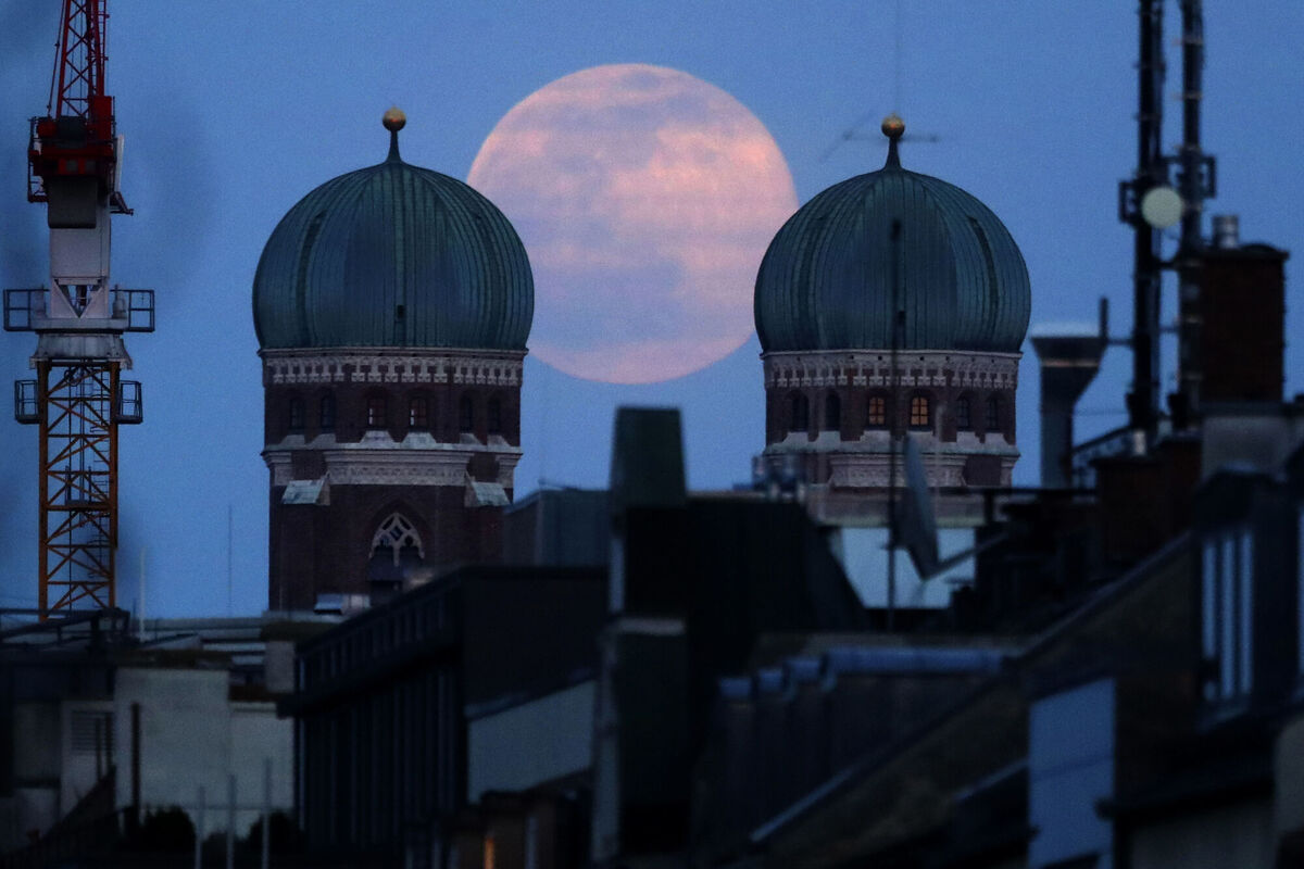 The full moon rises behind the Church of our Lady in Munich, Germany, Sunday, March 28, 2021. The March full moon in March is called the "Worm Moon." (AP Photo/Matthias Schrader)
