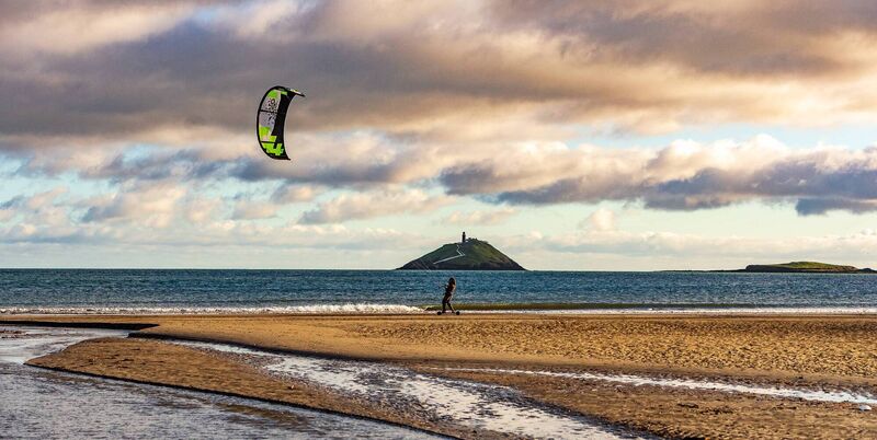 Kiteboarder Gabriel Fekete enjoying the wind and sun on Ballynamona beach. Picture: Mark Leo.
