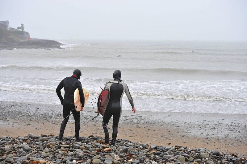 Surfers Kevin Healy, Minane Bridge and Kevin O'Connell, Carrigaline get set to hit the waves during Storm Dennis at Fountainstown, Co Cork in February 2020. Pic; Larry Cummins