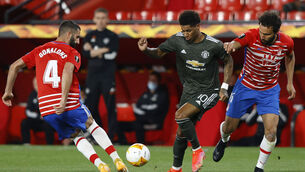 <p>Manchester United's Marcus Rashford, tries to beat Granada's Maxime Gonalons, left, and German at the Los Carmenes Stadium tonight. Picture: AP Photo/Fermin Rodriguez</p>