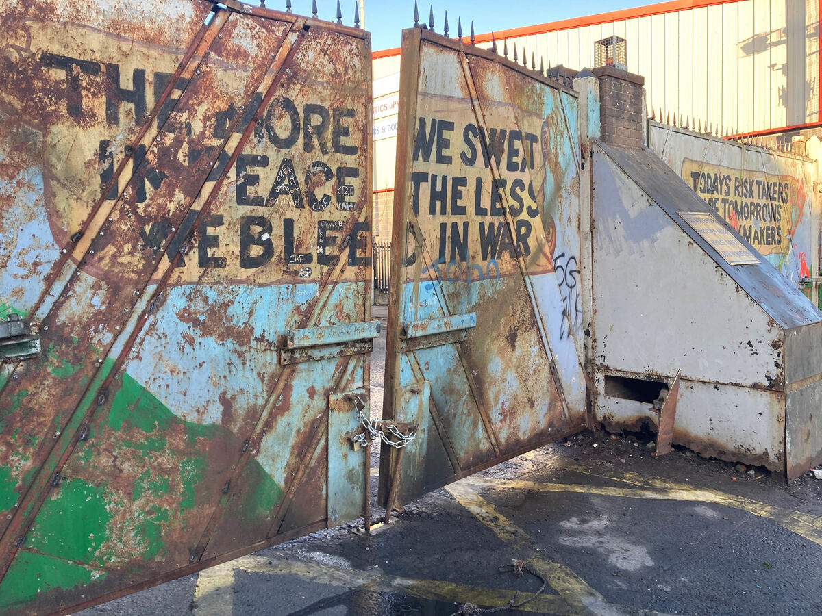 A cleanup operation underway at Lanark Way in west Belfast, following scenes of violent disorder over recent nights. Repair work was carried out on a peace wall gate, pictured, separating the loyalist and republicans communities after it was set on fire during rioting.