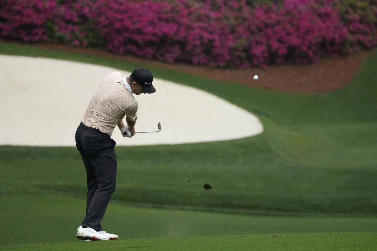 Justin Rose, of England, chips to the 13th green during the third round of the Masters golf tournament on Saturday, April 10, 2021, in Augusta, Ga. (AP Photo/Charlie Riedel)