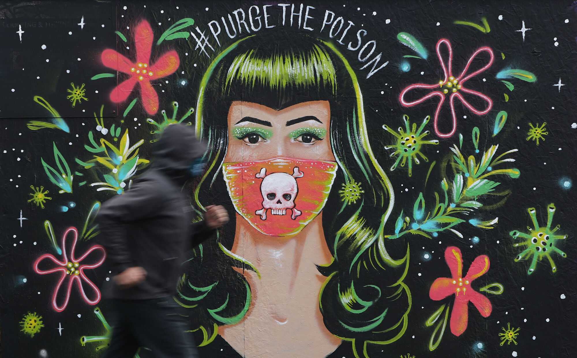 A jogger passes a mural by Brazilian artist Gabriel Marques in Dublin's Grand Canal area, during Covid-19 lockdown. Picture: Niall Carson/PA Wire