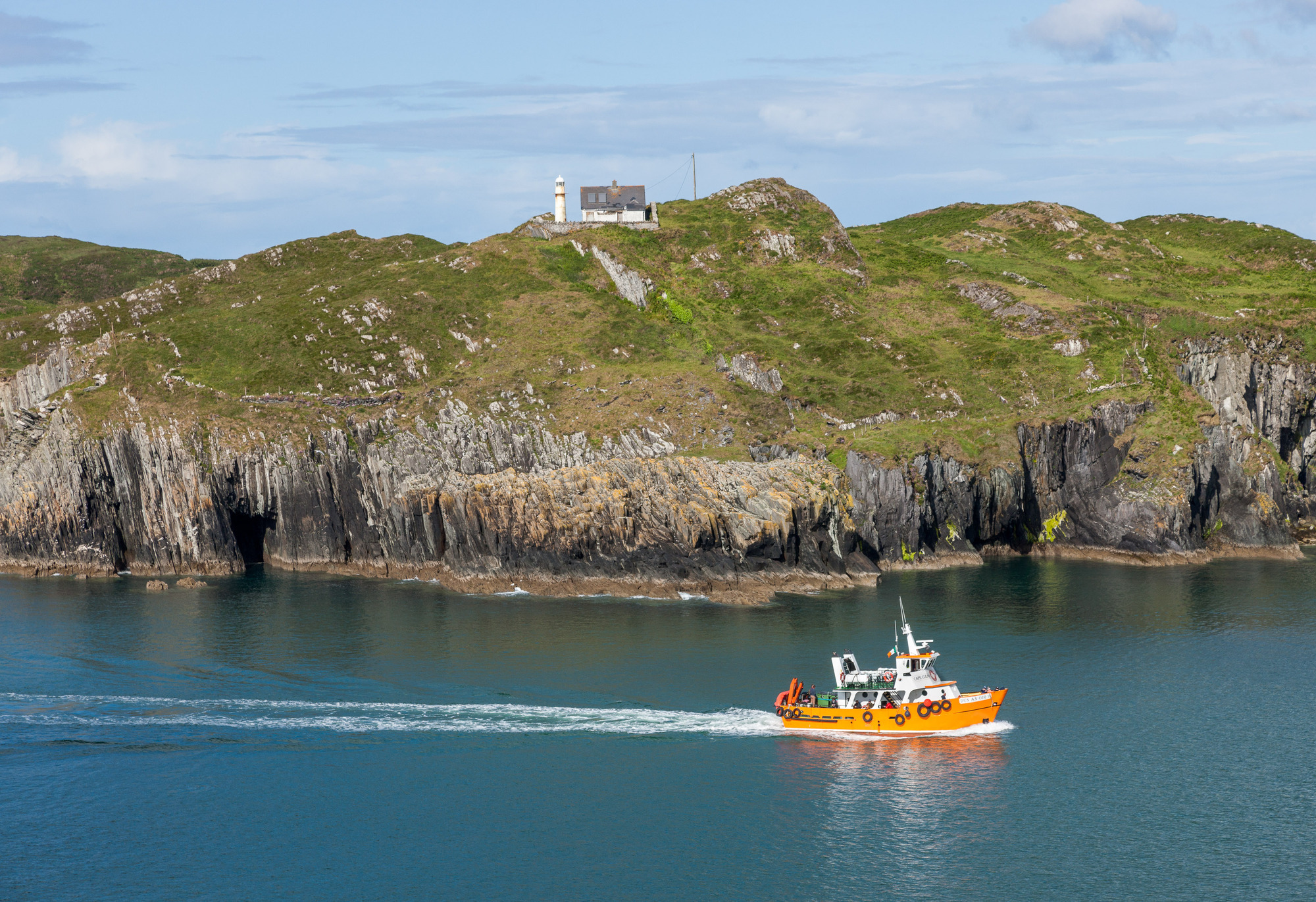 Ferry boat Dun an Óir II passes the lighthouse on Sherkin Island after making the early morning short trip from Cape Clear to Baltimore. Picture: David Creedon / Anzenberger
