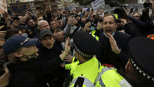 <p class="contextmenu internal_Caption">Chelsea former star goalkeeper and now technical advisor Petr Cech, at right, behind a line of policemen, tries to calm down fans protesting outside Stamford Bridge last night, against Chelsea’s decision to join a new European Super League. Just a few hours later Chelsea confirmed their intent to pull out of the project.  <span class="contextmenu emphasis CaptionCredit">Picture: AP Photo/Matt Dunham</span>
            </p>