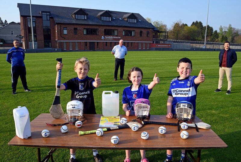 Getting ready for the return of under-age GAA at Sarsfields Hurling Club, Cork, with hand sanitiser on site are Luke, Ethan and Isabelle O'Brien with their father Finbarr, coaching officer, (left); Tadhg Murphy, club chairman, and Daniel Kearney, senior club captain, who will assist with underage coaching also. Picture Denis Minihane. Getting ready for the return of under-age GAA at Sarsfields Hurling Club, Cork, with hand sanitiser on site are Luke, Ethan and Isabelle O'Brien with their father Finbarr, coaching officer, (left); Tadhg Murphy, club chairman, and Daniel Kearney, senior club captain, who will assist with underage coaching also. Picture Denis Minihane.