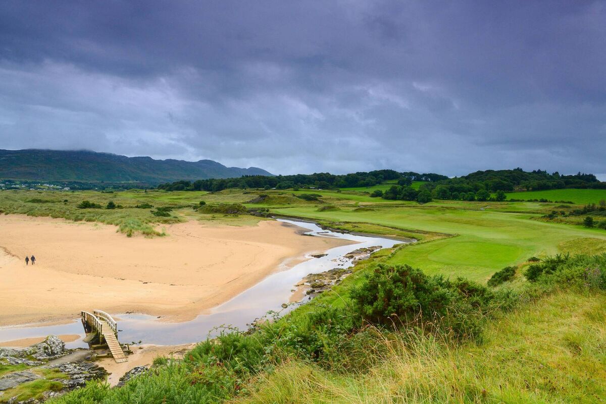 A couple walk on the beach alongside the 2nd hole at Portsalon Golf Club, Fanad, Co Donegal. Picture: Kevin Markham