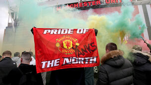 <p>A fan holds up a banner as they protest against the Glazer family (Barrington Coombs/PA)</p>