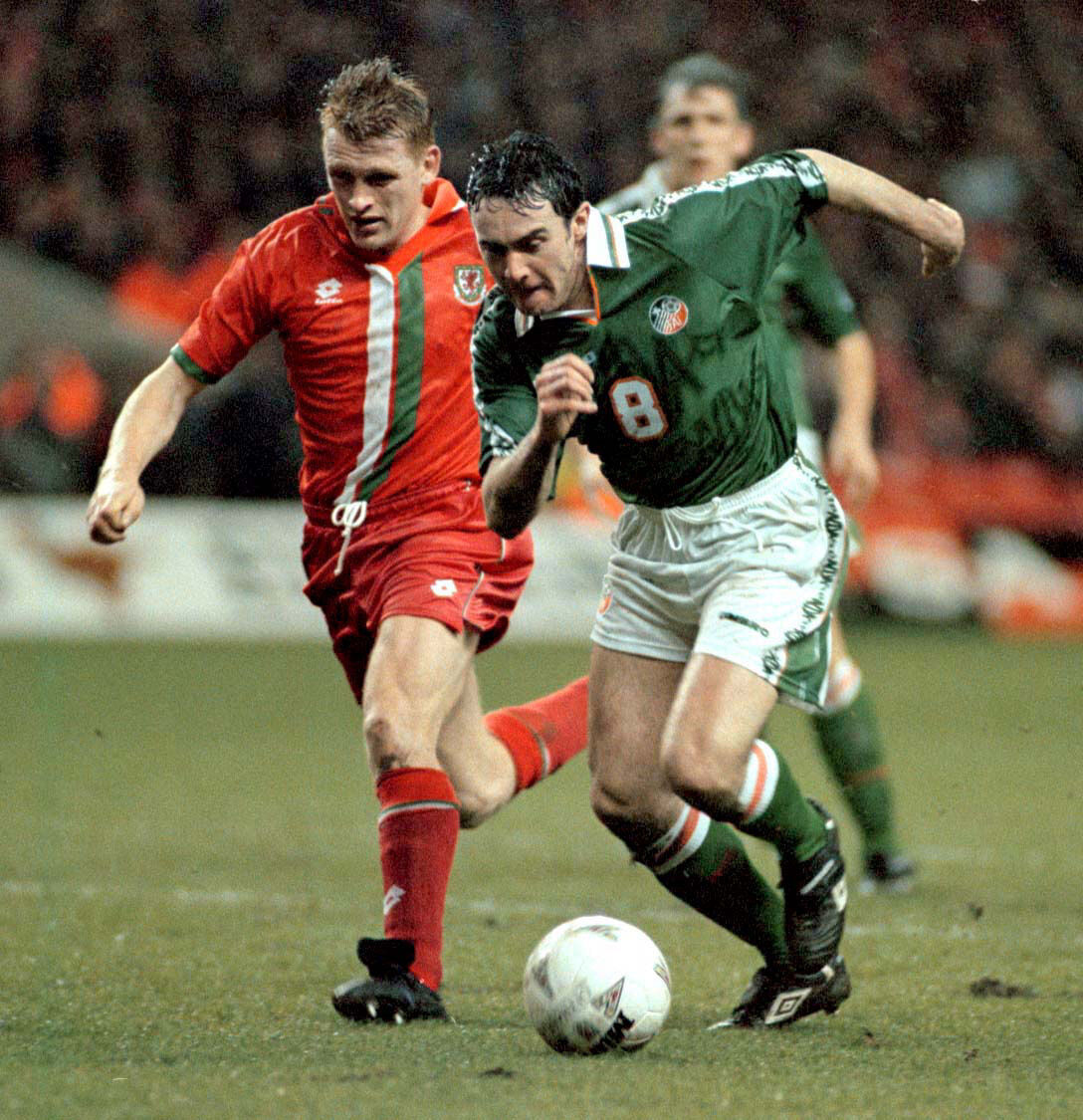 McLoughlin gets past Wales' Mark Pembridge during a friendly in Cardiff. Picture: David Jones/PA.