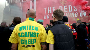 <p>A fan wears a shirt with a "United Against Greed" message as fans gather to protest against the Glazer family, the owners of Manchester United, at Old Trafford. Photo: Barrington Coombs/PA</p>