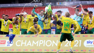 <p>Norwich City celebrate with the trophy at Oakwell Stadium. Picture: Mike Egerton/PA</p>
