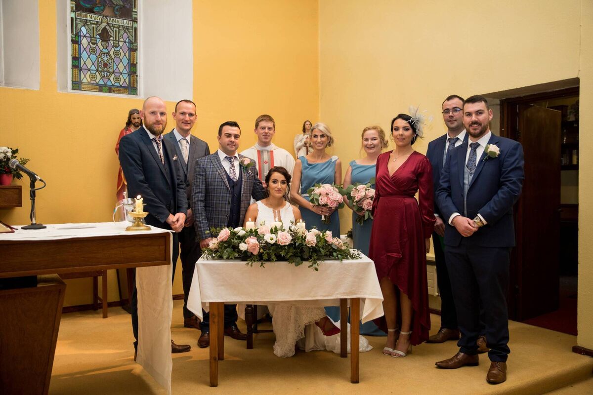 Katie Murphy and Kieran Harty with Fr Shane O'Neill and wedding party and guests in Glendine Church