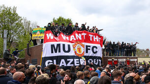<p>Fans hold up banners as they protest against the Glazer family, owners of Manchester United, before their Premier League match against Liverpool at Old Trafford, Manchester (Barrington Coombs/PA)</p>