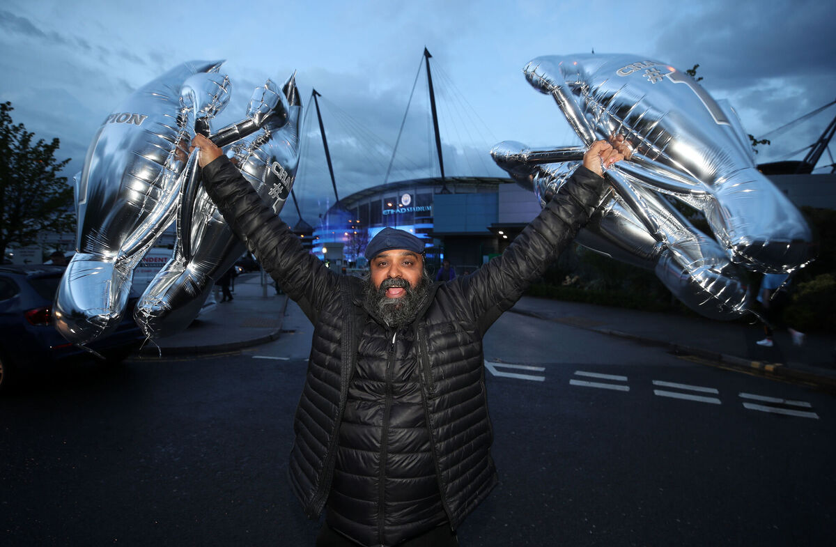 A Manchester City fan celebrates at the Etihad Stadium. Photo: Nick Potts/PA