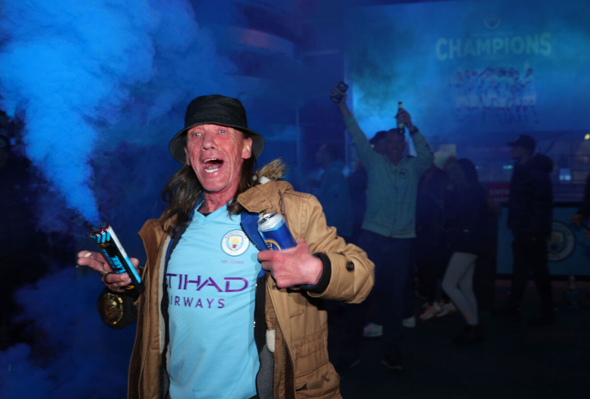 Manchester City fans celebrate at the Etihad Stadium after Manchester City were crowned Premier League champions following Manchester United’s home defeat to Leicester. Picture: Peter Byrne/PA