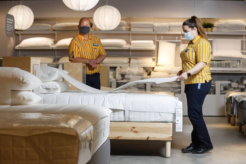 Ikea staff demonstrate how disposable covers will be used in the mattress department for safe testing by customers. Picture: Conor McCabe Photography Ikea staff demonstrate how disposable covers will be used in the mattress department for safe testing by customers. Picture: Conor McCabe Photography
