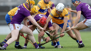 <p>Clare and Wexford players contest a loose ball. Picture: INPHO/Bryan Keane</p>