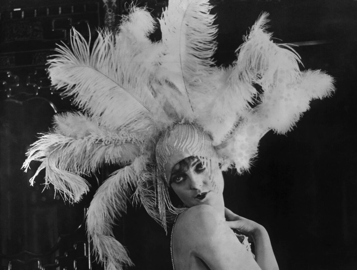 A 1920s flapper in beaded feather headdress.