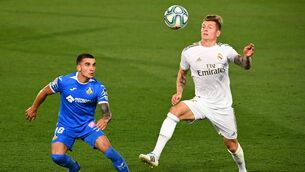 <p>Getafe's Uruguayan midfielder Mauro Arambarri (L) challenges Real Madrid's German midfielder Toni Kroos during the LaLiga match with Real Madrid at the Alfredo di Stefano stadium on July 2, 2020. (Photo by GABRIEL BOUYS / AFP) (Photo by GABRIEL BOUYS/AFP via Getty Images)</p>