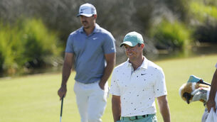 <p>Rory McIlroy, right, walks up to the 13th green with Brooks Koepka. Picture: Matt York</p>