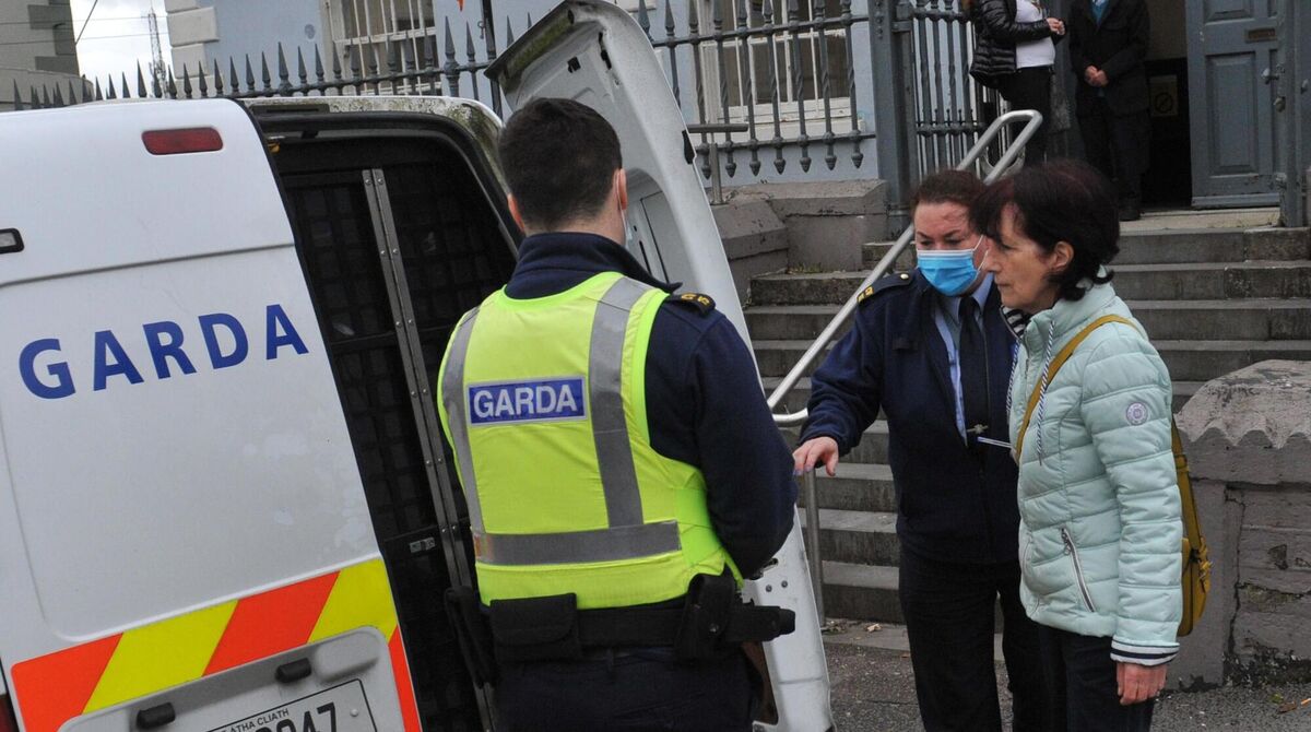 Margaret Buttimer (pictured, right) being taken into custody. In Bandon district court Ms Buttimer again did not wear a face mask, leading to the judge having her immediately placed in custody for contempt of court. Photo: Larry Cummins