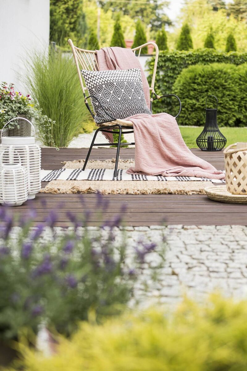 Granite block setts, decking and gravel paths create a gentle, bohemian patio frothing in container planting in a simple one-level open patio that could be tackled by a weekend warrior for an area by the house our out in the garden.