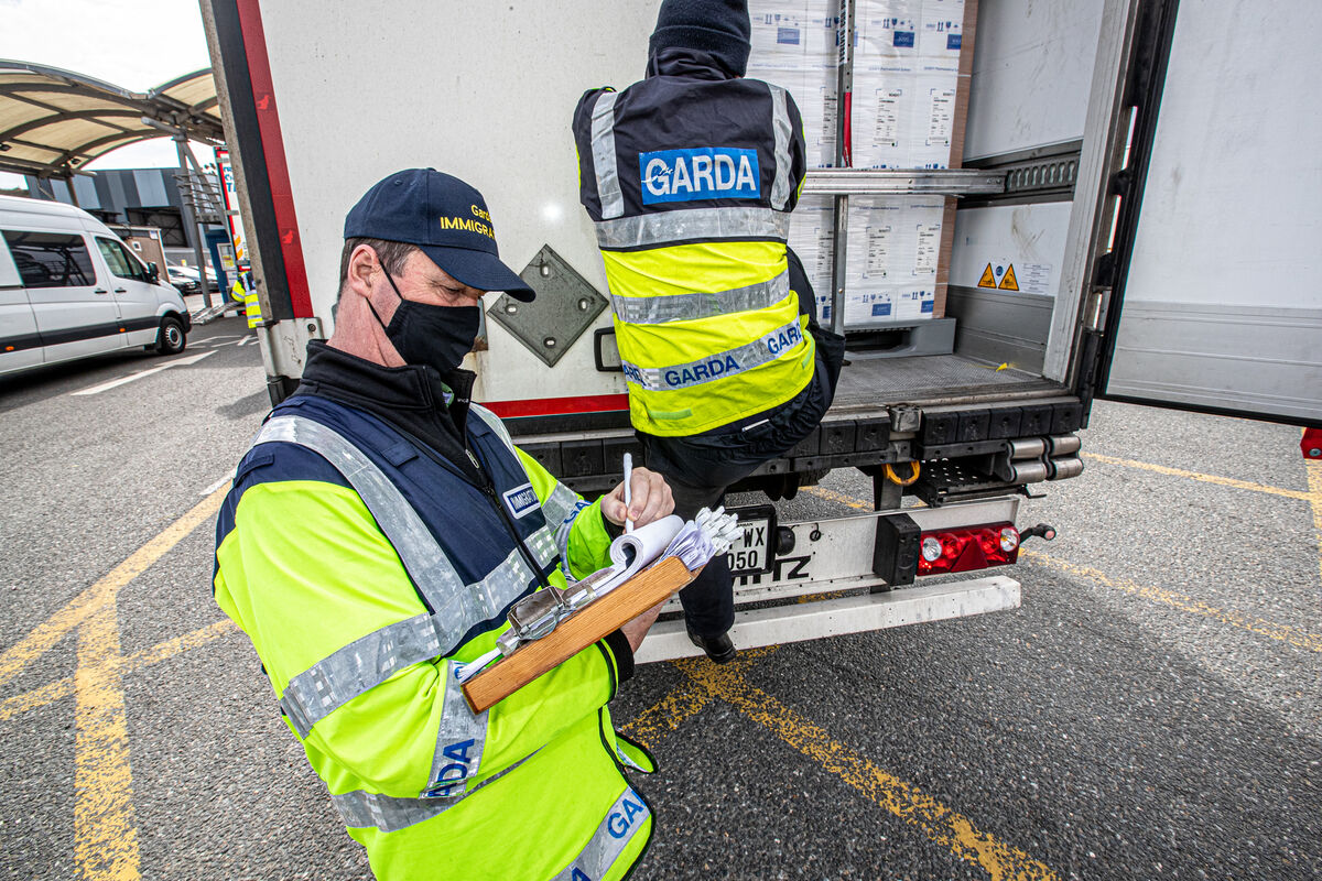 Sergeant Mick Morrissey (right) and a colleague checking the tag at the back of a trailer at Rosslare Euro Port, Co Wexford, as part of their routine operations at the port. Picture: Neil Michael Sergeant Mick Morrissey (right) and a colleague checking the tag at the back of a trailer at Rosslare Euro Port, Co Wexford, as part of their routine operations at the port. Picture: Neil Michael