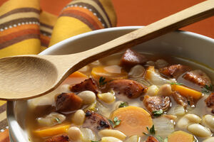 Winter vegetable and bean soup with spicy sausage