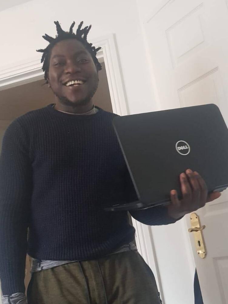 A happy resident in Knockalisheen Direct Provision Centre in Co. Clare with a new laptop he received from the Windows4Opportunity project 