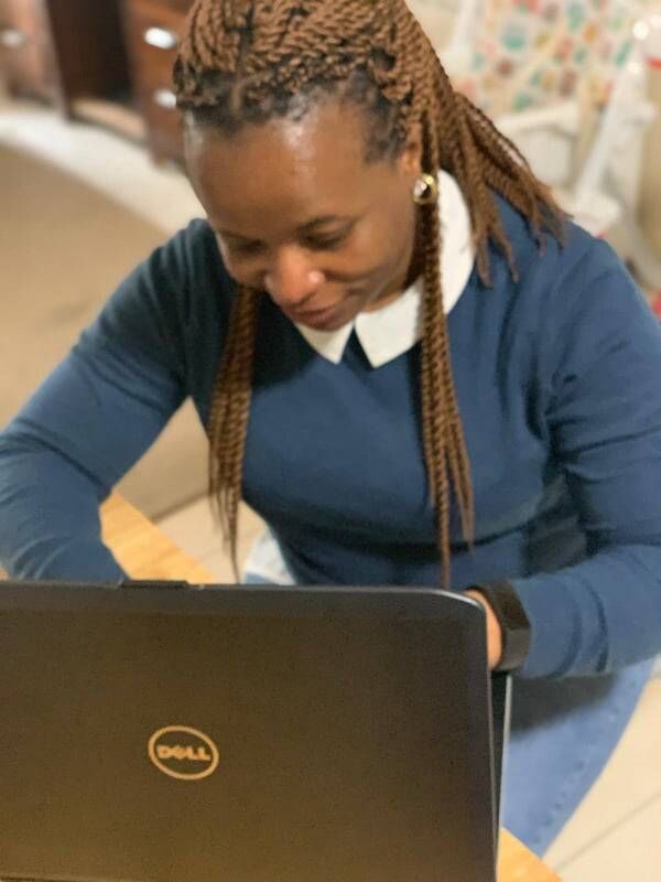 Deborah O with a laptop she received from the Windows 4 Opportunity project 