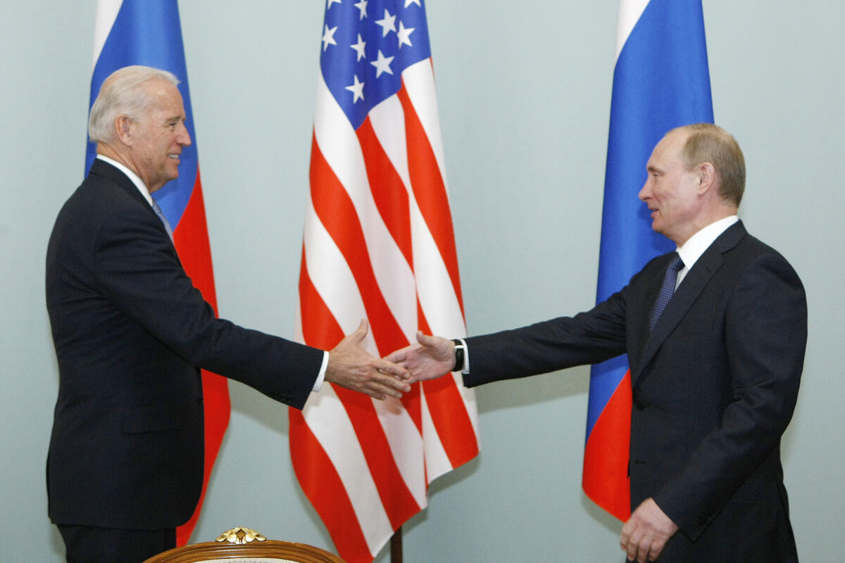 Then US Vice President Joe Biden, left, shakes hands with Russian President Vladimir Putin in Moscow in March 2011. President Joe Biden will hold a face-to-face meeting with Vladimir Putin next month in Geneva. Photo: AP/Alexander Zemlianichenko)