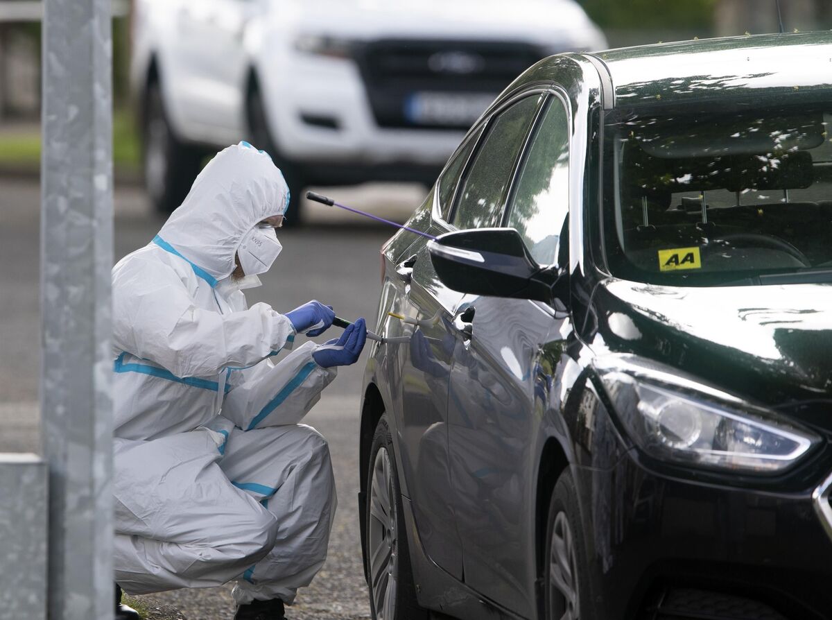 Members of the Garda Technical Bureau examine the unmarked Garda car. Pic: Colin Keegan, Collins 