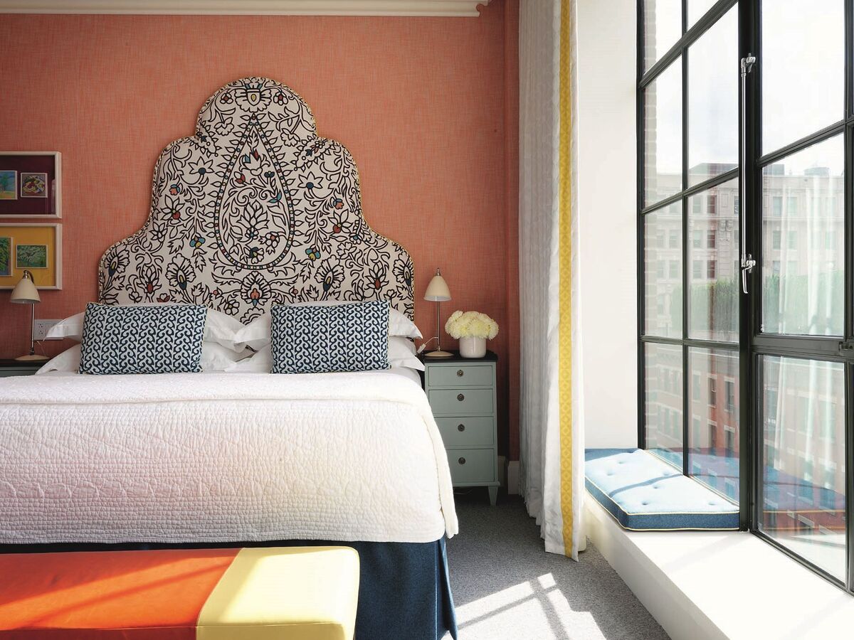  Soaring headboards in beautiful fabrics and drapery with leading edges are characteristics of Kit Kemp's style.