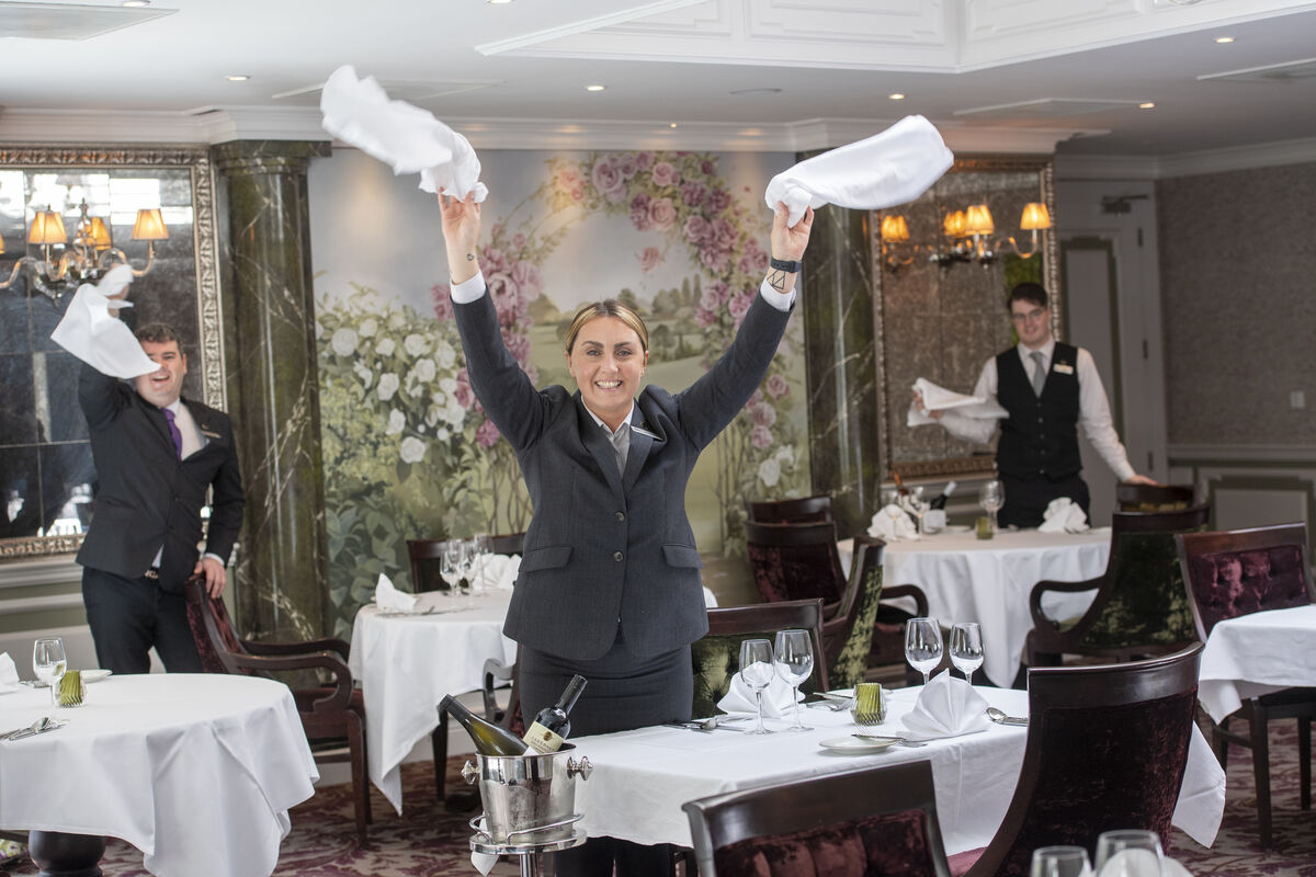 Daniel Griffin, assistant manager, Tralee, Jennifer Dee, Ballyheigue, and Oliver Thornton, Tralee, get the Rose Room restaurant ready for customers at The Rose Hotel, Tralee, Co Kerry. Picture: Domnick Walsh Daniel Griffin, assistant manager, Tralee, Jennifer Dee, Ballyheigue, and Oliver Thornton, Tralee, get the Rose Room restaurant ready for customers at The Rose Hotel, Tralee, Co Kerry. Picture: Domnick Walsh