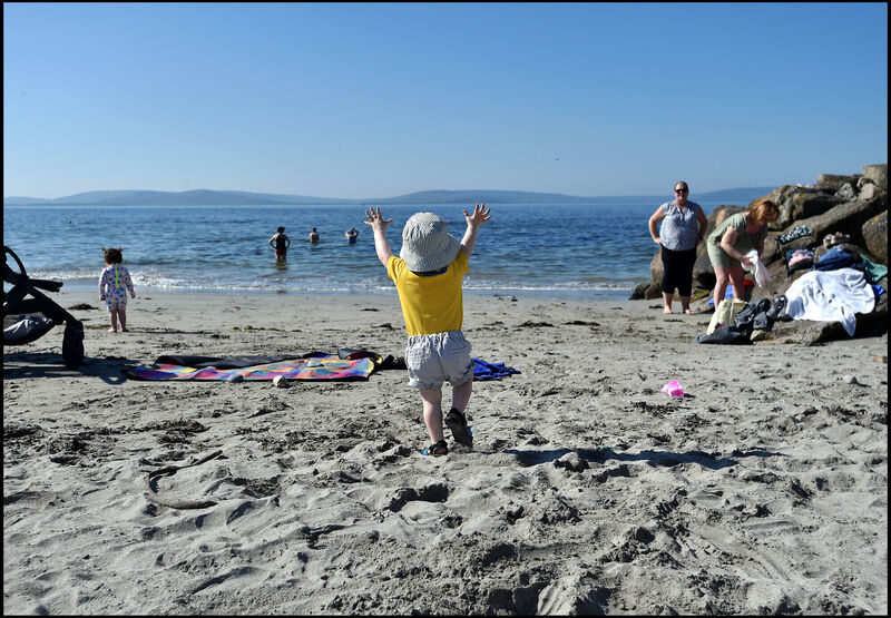 Simon Conlon makes a dash for the sea at the beach in Salthill, as the fine weather hit over 20 degrees celsius. Picture: Ray Ryan