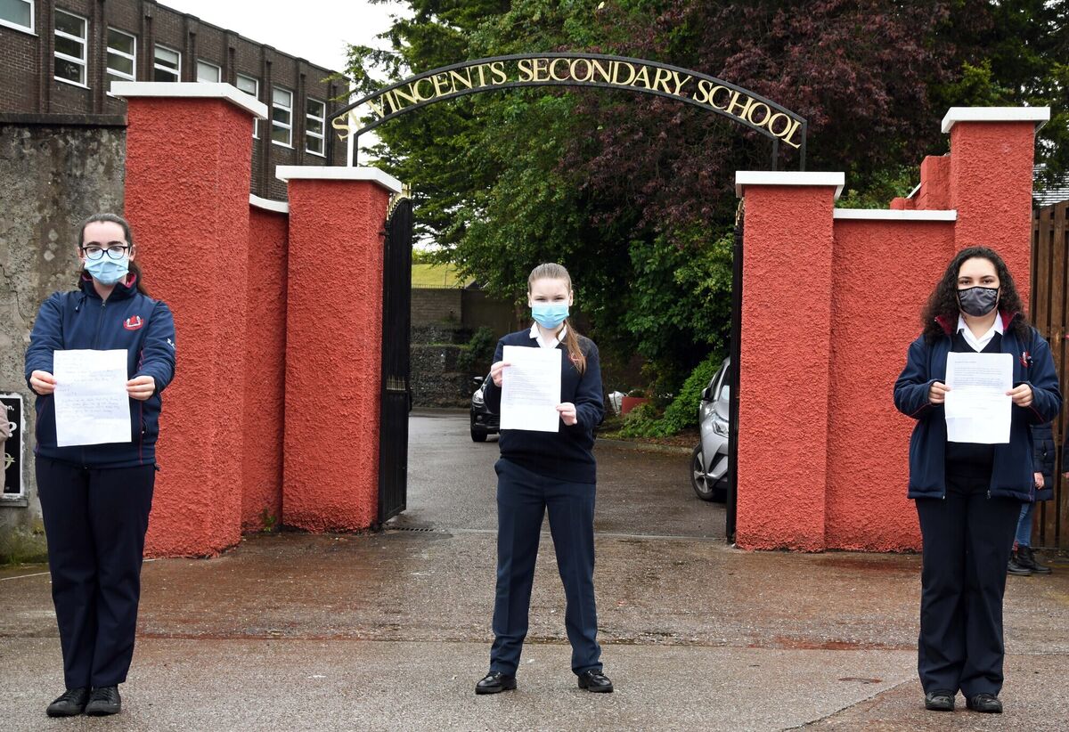 Three of the students Katie Coleman, Éilish Hickey and Laila Abdelnapy holding letters they wrote at the socially distanced protest outside the grounds of St Vincent's Girls Secondary School. Photo: Denis Minihane