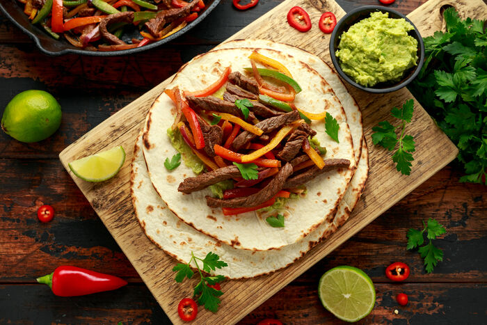 Beef fajitas with tomato and coriander salsa and guacamole