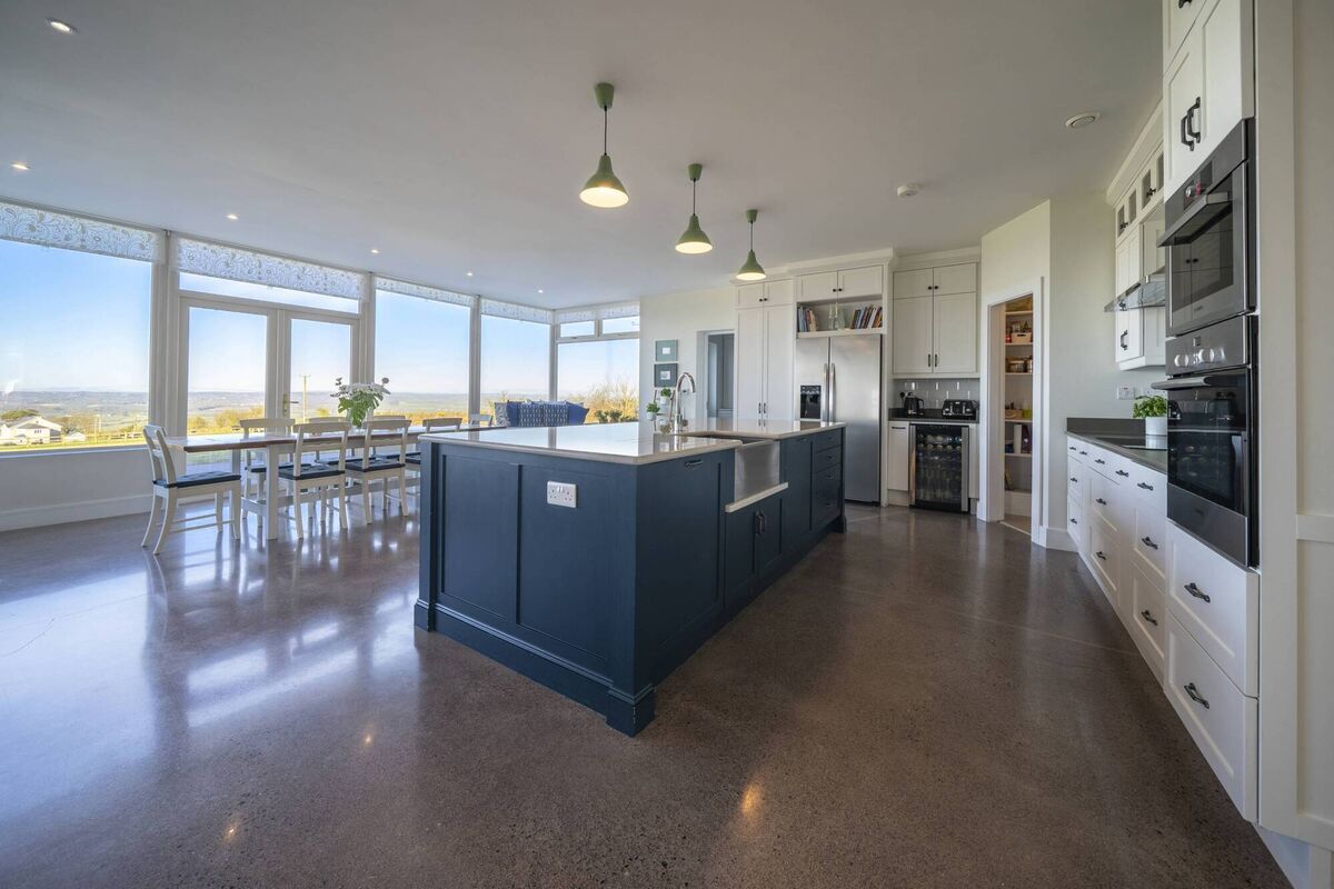 Accommodation includes a scene-stealing kitchen/diner, with extensive white and blue units plus island