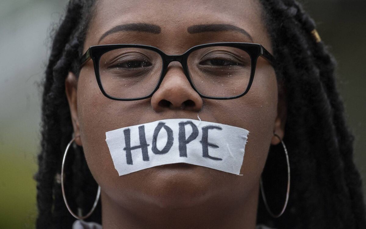 A woman wears a message on her mask as she takes part in a silent prayer for victims of the 1921 Tulsa Massacre on the 100-year anniversary in the city. Photo: ANDREW CABALLERO-REYNOLDS / AFP) via Getty Images
