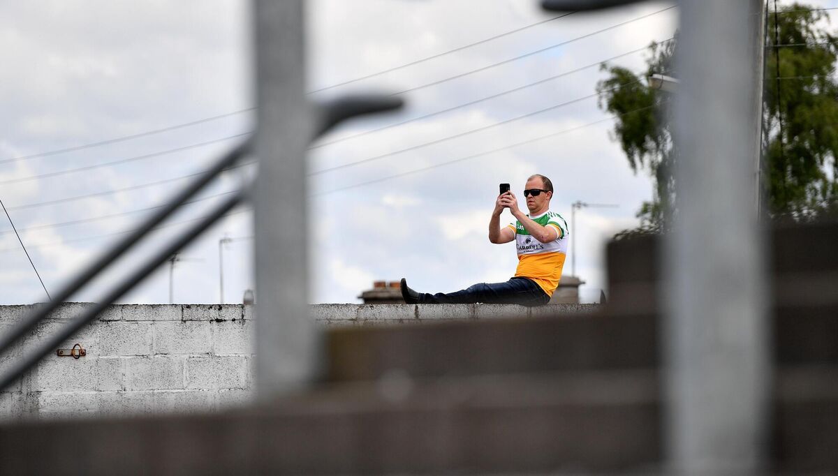 Offaly supporter Brendan Monaghan, from Kilcormac, watches the game from outside the grounds. Picture: Sam Barnes/Sportsfile