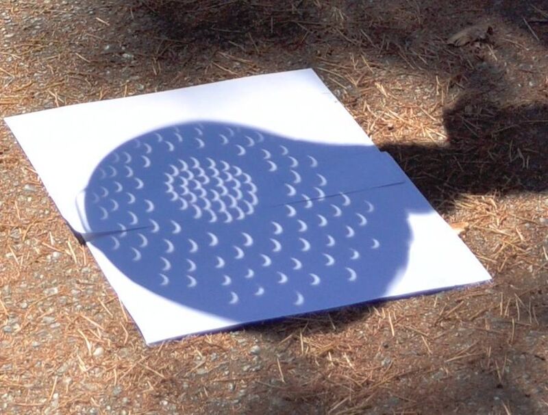 Old-school projection of solar eclipse using a colander. Picture: Joe Mabel Old-school projection of solar eclipse using a colander. Picture: Joe Mabel