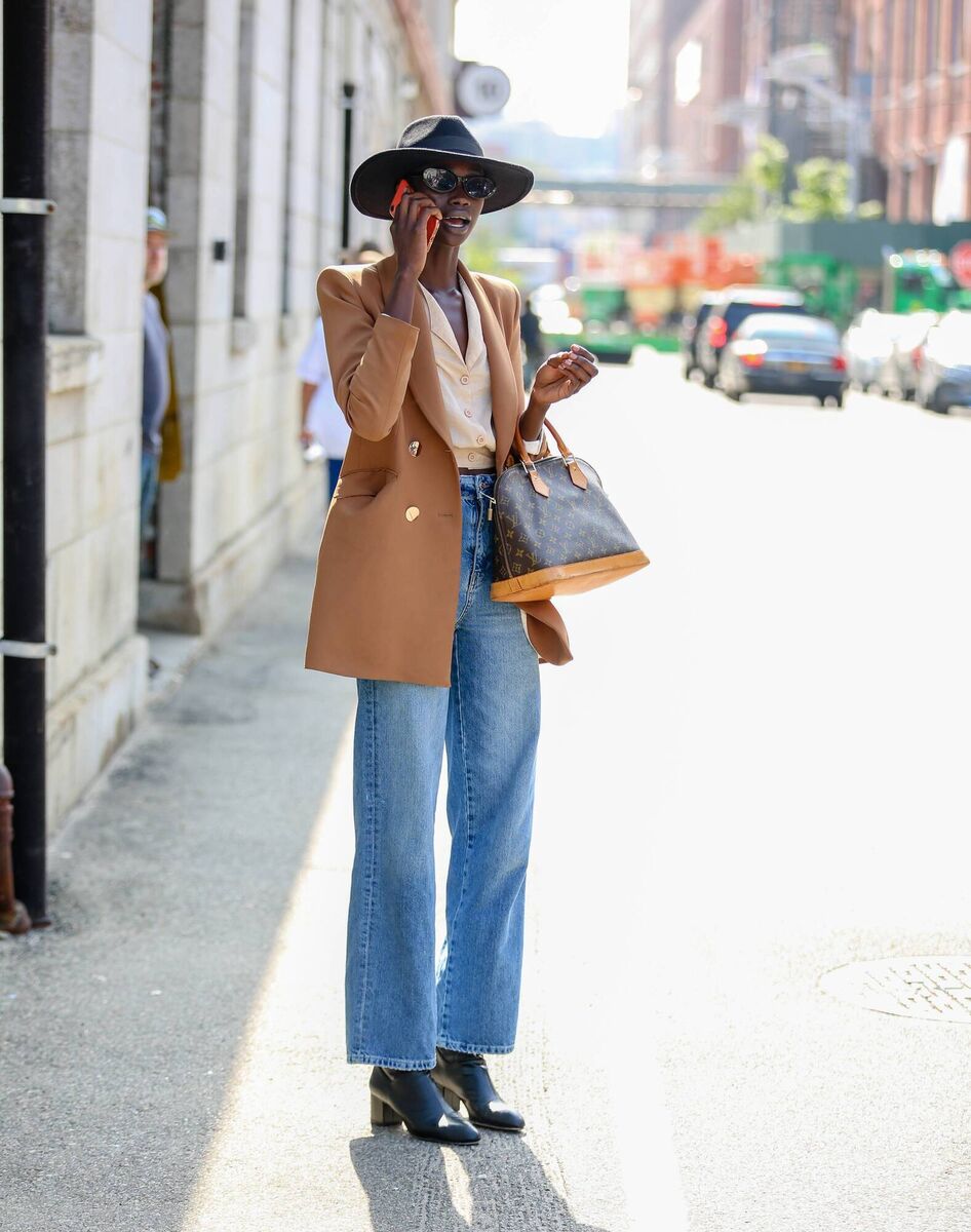  A guest is seen wearing a brown blazer, beige top and blue jeans during New York Fashion Week on September 11, 2019 in New York City. (Photo by Donell Woodson/Getty Images)