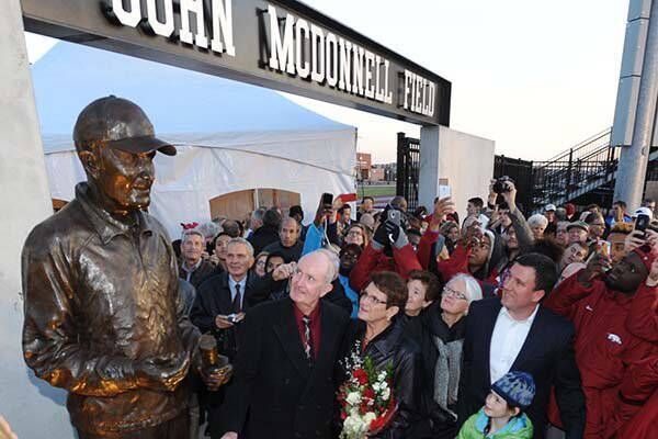 FIELD OF DREAMS: John McDonnell, former University of Arkansas cross country and track and field coach, and his wife Ellen, smile as a cover is removed from a statue in his honour during a ceremony at Fayetteville in 2014. Picture: Arkansas Democrat Gazette FIELD OF DREAMS: John McDonnell, former University of Arkansas cross country and track and field coach, and his wife Ellen, smile as a cover is removed from a statue in his honour during a ceremony at Fayetteville in 2014. Picture: Arkansas Democrat Gazette