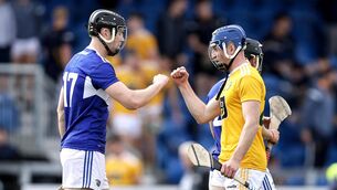 <p>Antrim's Niall McCormack fist pumps Matthew Whelan of Laois after the game</p>