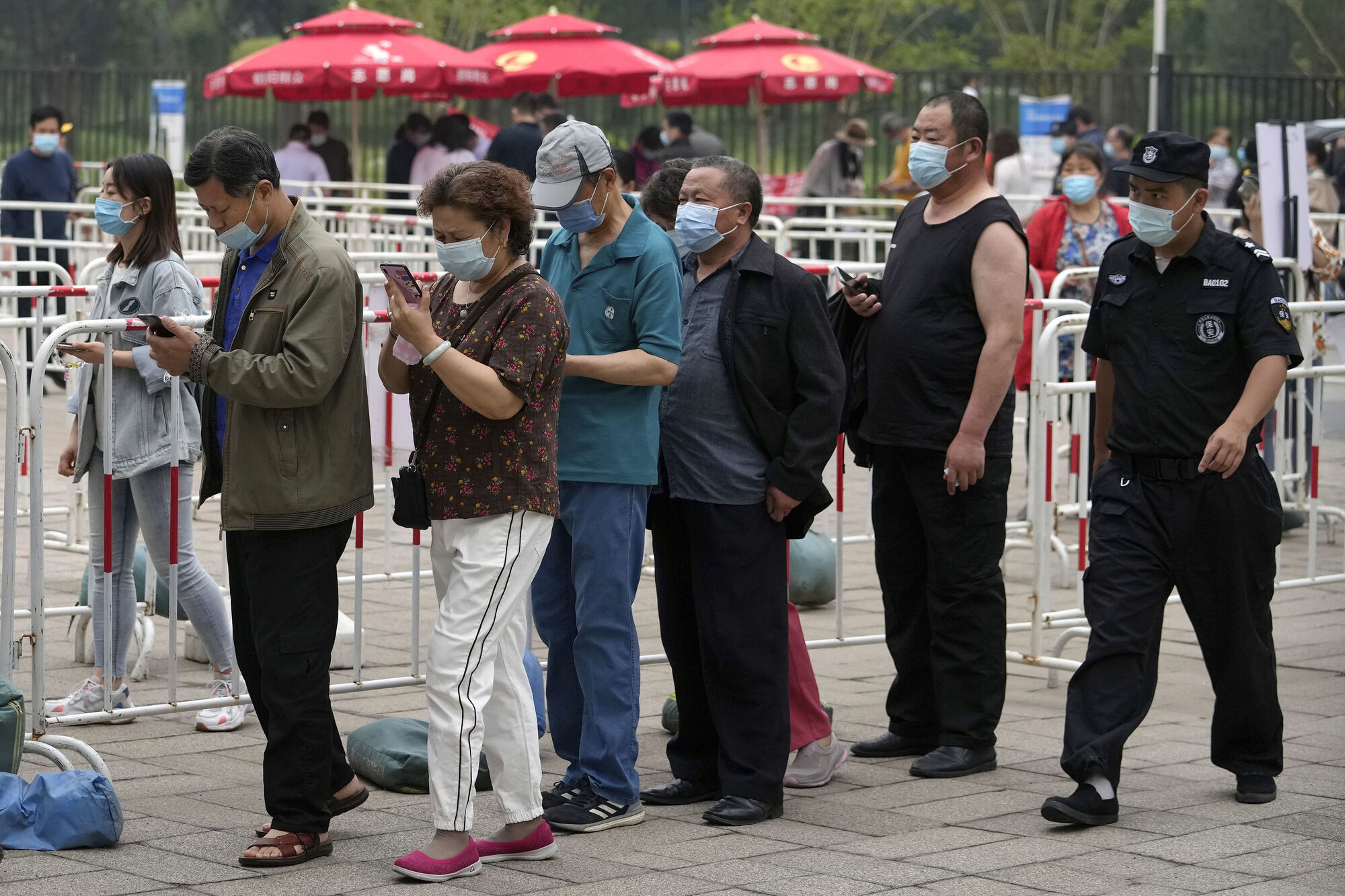 Residents line up to receive the Sinopharm Covid-19 vaccine at a vaccination center in the Central Business District in Beijing recently. After a slow start, China is now administering shots at a staggering pace. Photo: AP/Andy Wong